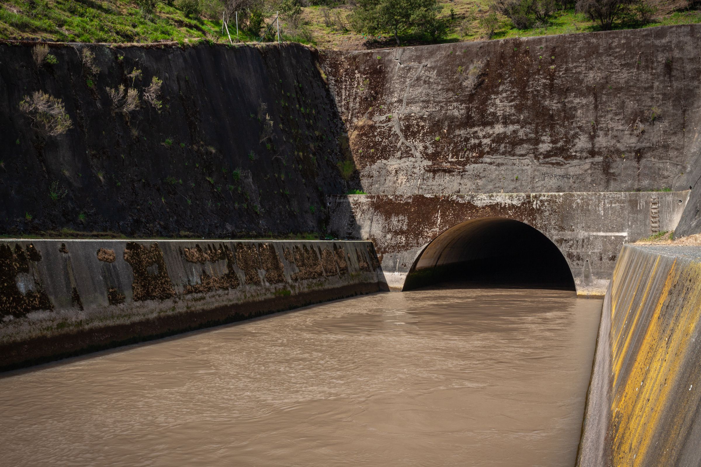 Stormwater flowing through a large concrete culvert